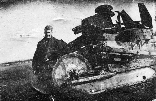 Charles Browne standing in front of an Army tank in France